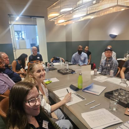 Club members smiling and talking during an in-person gathering